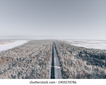 Snow Road In Forest. View At Road From Sky