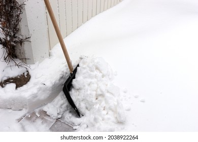 Snow Shovel To Clear The Snow In Front Of The Garage Door