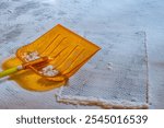 snow shovel on fresh snow standing on the steps of a building, orange color, the problem of icing, injuries and fractures of people when slipping on ice