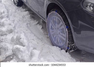 The Snow Sock Covered Front Wheel Car When Driving On The Snowy Road, Feeling Safe. Concept Drive Safe On The Snowy Day.