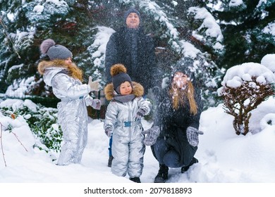 Snow Time, Snow Games. Winter Vacation. Cute Caucasian Kids Brother And Sister And Mom With Dad Are Playing In The Yard Of Their House. Snow Throwing Fun During Winter Break