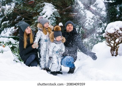 Snow Time, Snow Games. Winter Vacation. Cute Caucasian Kids Brother And Sister And Mom With Dad Are Playing In The Yard Of Their House. Snow Throwing Fun During Winter Break