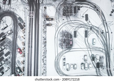 Snow Wheel Prints Creating Intresting Chaotic Patters. Top Down Aerial View Over Car Park At Winter.