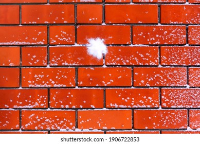 Snowball Splat On The Snowy Brick Wall. Full Frame