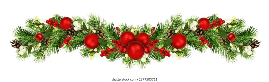 Snowberries with green twigs of Christmas tree, red decorations and cones in a holiday waved garland isolated on white