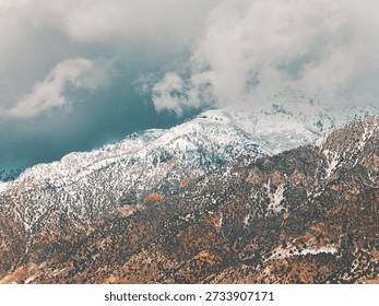 Snow-blanketed mountain range and brooding clouds.