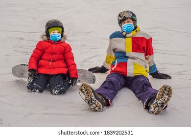 Snowboard Instructor Teaches A Boy To Snowboarding Wearing A Medical Mask During COVID-19 Coronavirus. Activities For Children In Winter. Children's Winter Sport. Lifestyle