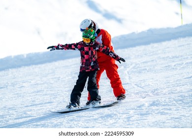 Snowboard School. Boy with Instructor Learning Snowboarding.