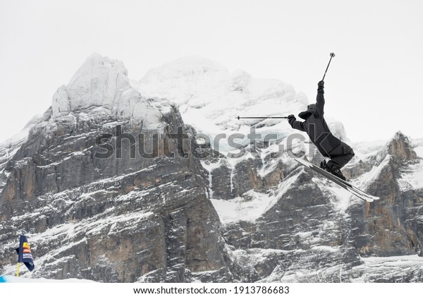 Snowboard ski freestyle big air\
contest in the background Mittelhorn mountain. Snowboard tricks,\
ski tricks. Jungfrau region Grindelwald,\
Switzerland