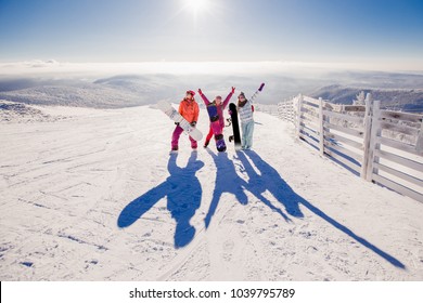 Snowboard. Team Of Girls People Watching Sunrise Surrounded By Snow And Fir Trees, Mountains. Concept Travel, Ski Resort, Friends