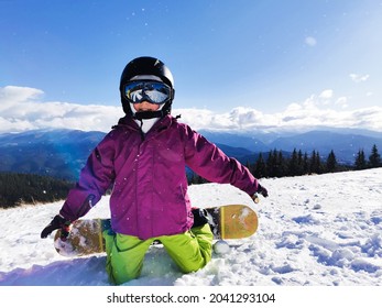 Snowboard Winter Sport. Little Kid Girl Playing With Snow Wearing Warm Winter Clothes. Winter Background