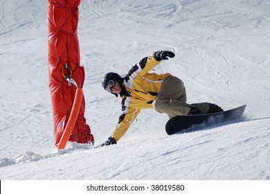 Snowboarder Carving Around A Red  Column