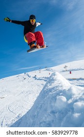 Snowboarder Executing A Radical Jump Against Blue Sky.