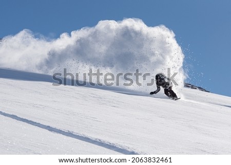 Snowboarder getting some fresh turns