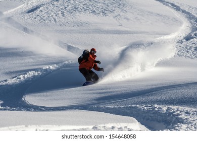 Snowboarder go down on powder snow. - Powered by Shutterstock