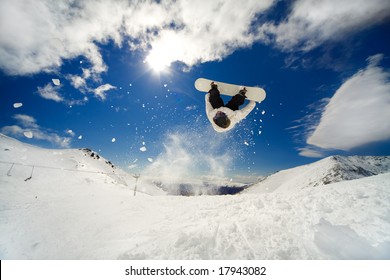 Snowboarder Going Off Jump Doing A Backflip