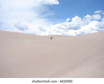 Snowboarder hiking up the Great Sand Dunes