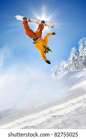 Snowboarder jumping against blue sky