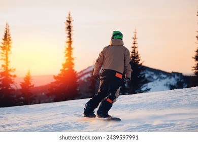 Snowboarder jumping extreme winter sports on background snowy forest, Sheregesh ski resort, sunset light. - Powered by Shutterstock