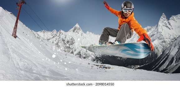 Snowboarder Jumping Through Air With Deep Blue Sky In Background. Winter Sport Background. 