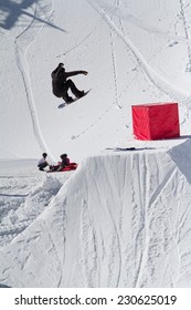 Snowboarder jumps in Snow Park,  mountain ski resort 