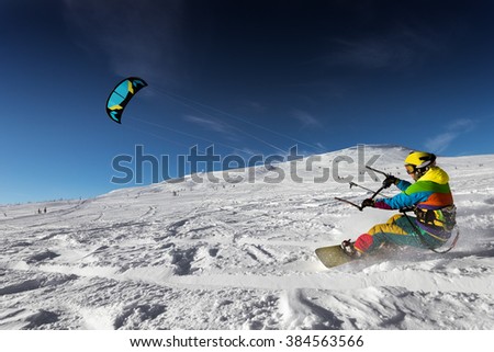 Snowboarder with kite on free ride. Sheregesh resort, Siberia, Russia
