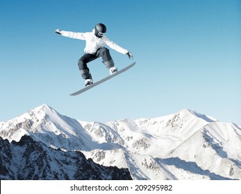 Snowboarder Making High Jump In Clear Blue Sky