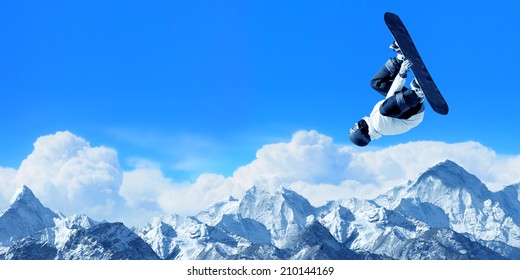 Snowboarder Making High Jump In Clear Blue Sky