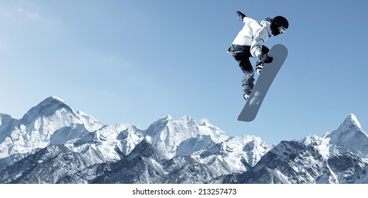 Snowboarder Making High Jump In Clear Blue Sky