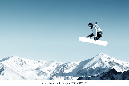 Snowboarder Making Jump High In Clear Sky