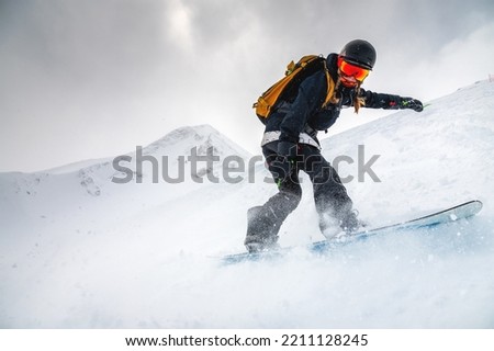 Similar – Foto Bild Aktive Person beim Snowboardfahren auf einem verschneiten Hügel