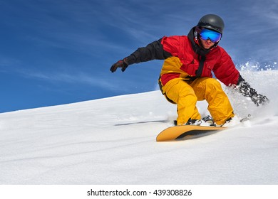 Snowboarder Riding Fast On A Dry Snow On Freeride Slope.