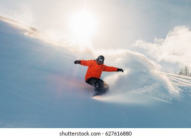 Snowboarder Is Riding With Snowboard From Powder Snow Hill