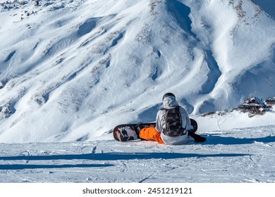 Snowboarder. Ski resort in the Dolomites. Ski slopes in the Dolomites. Alpine skiing sport and recreation. Snowboarders sit on top of a mountain. - Powered by Shutterstock