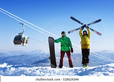 Snowboarder and skier on mountain against ski lift - Powered by Shutterstock