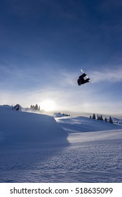 Snowboarder Spinning Doing A Grab In The Air