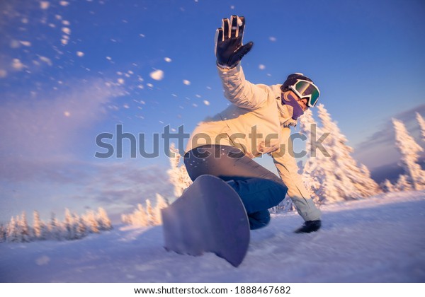 Snowboarder woman\
on snowboard rides through snow explosion. Freeride snowboarding in\
Sheregesh Ski\
Resort.