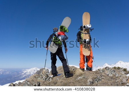 Snowboarders walking uphill for freeride, extreme sport