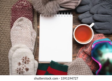 Snowboarding Tips Mock Up. Snowboard Gear List Template. Blank Page Notepad With Copy Space And Snowboard Googles, Cuf Of Black Tea On Brown Wooden Table Flat Lay Background.