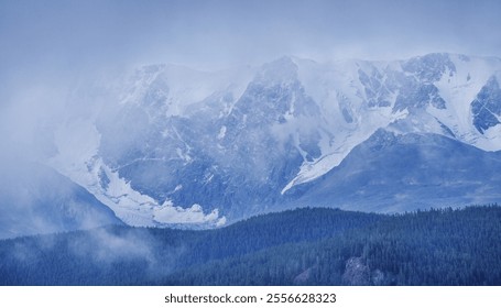 Snow-capped mountain  peaks in the clouds and fog, climbing mountain - Powered by Shutterstock