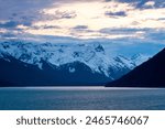 Snow-capped mountains at dusk along the Chilkoot Inlet near Haines, Alaska