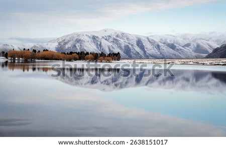 Snow-capped mountains reflected in Lake Clearwater in winter. Ashburton Lakes region. Canterbury. New Zealand.
