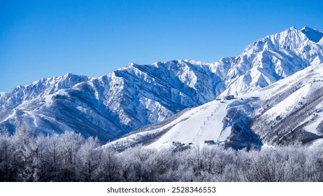 Snow-capped Northern Alps shining against a clear blue sky, Hakuba Village, Nagano Prefecture - Powered by Shutterstock