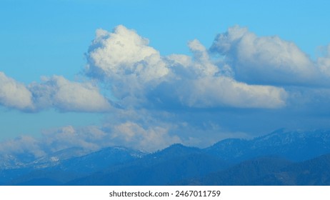 Snow-Capped Rocky Mountains With Blue Sky And Opposite Direction Clouds. - Powered by Shutterstock