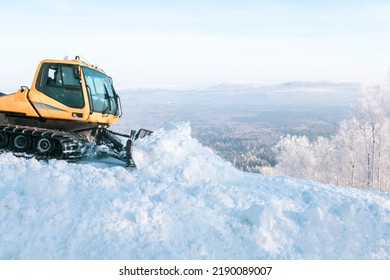 Snowcat Works On The Slope Of The Ski Slope, Leveling The Snow For Skiing.