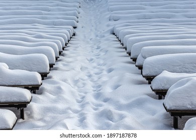 Snow-covered Benches After A Heavy Snowfall, In An Outdoor Concert Venue In A City Park