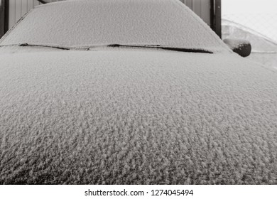 snow-covered car hood, the front part is thrown icing