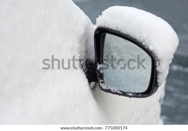 Snow-covered car rear view\
mirrors\
