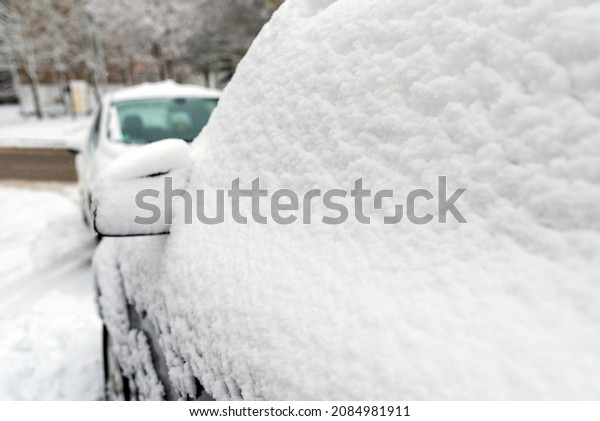 Snow-covered car windshield.Detail of a car\
covered with snow.Selective\
focus.