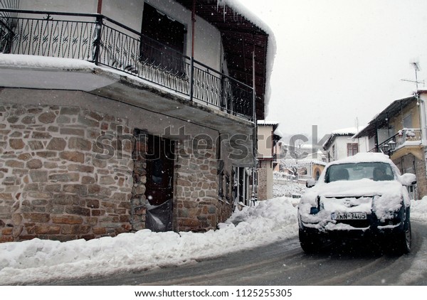 Snow-covered cars and houses in Arnea ,northern Greece\
on Feb. 8, 2012 